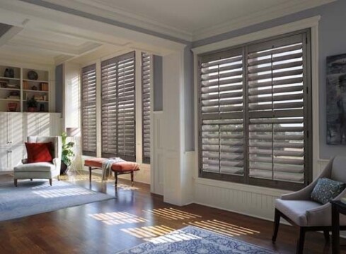 Sunny interior with wooden shutters and cozy furniture.