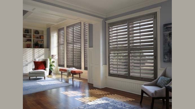 Sunny interior with wooden shutters and cozy furniture.